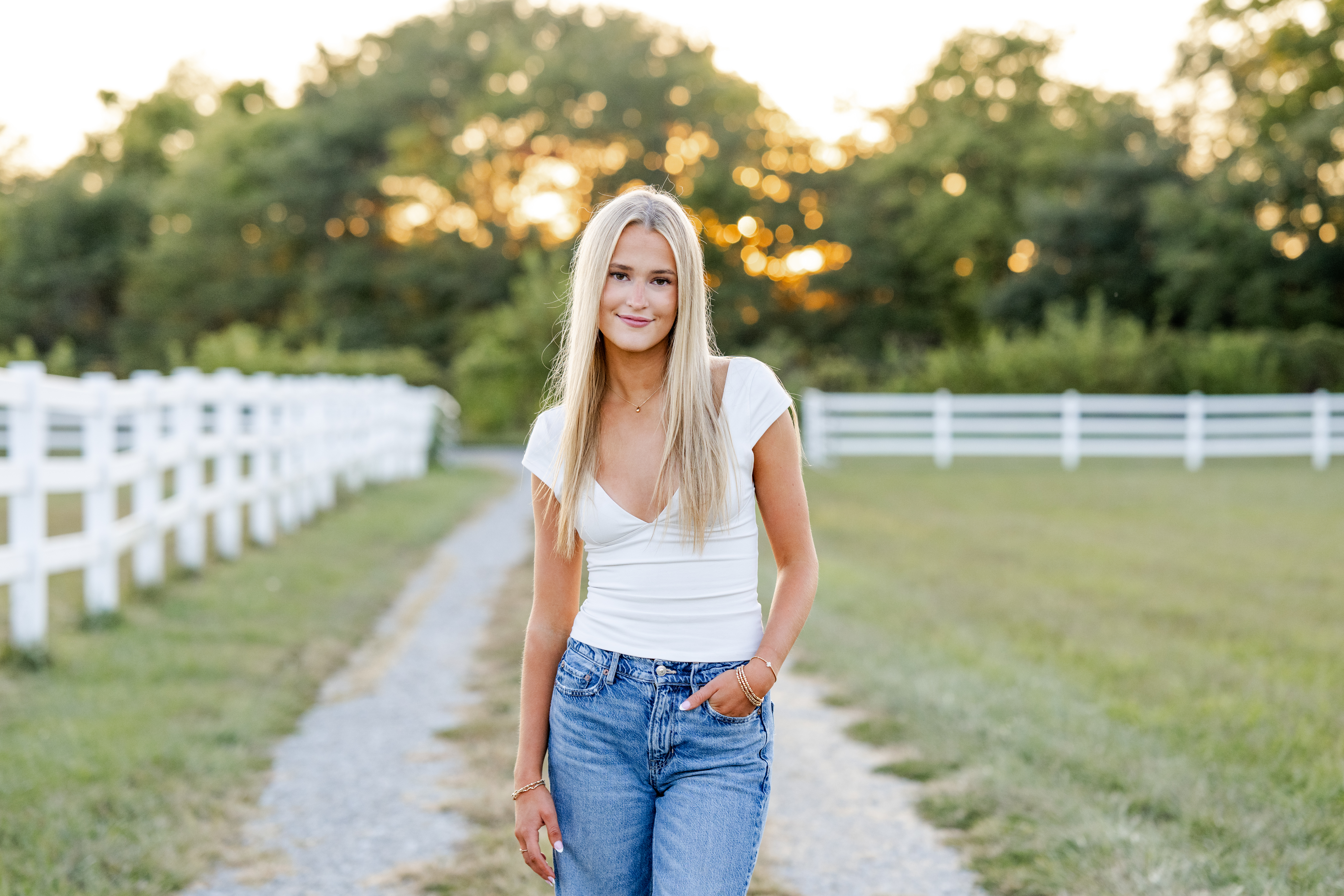 Westfield High School senior stands casually with hand in pocket during golden hour portraits in Sheridan, Indiana.